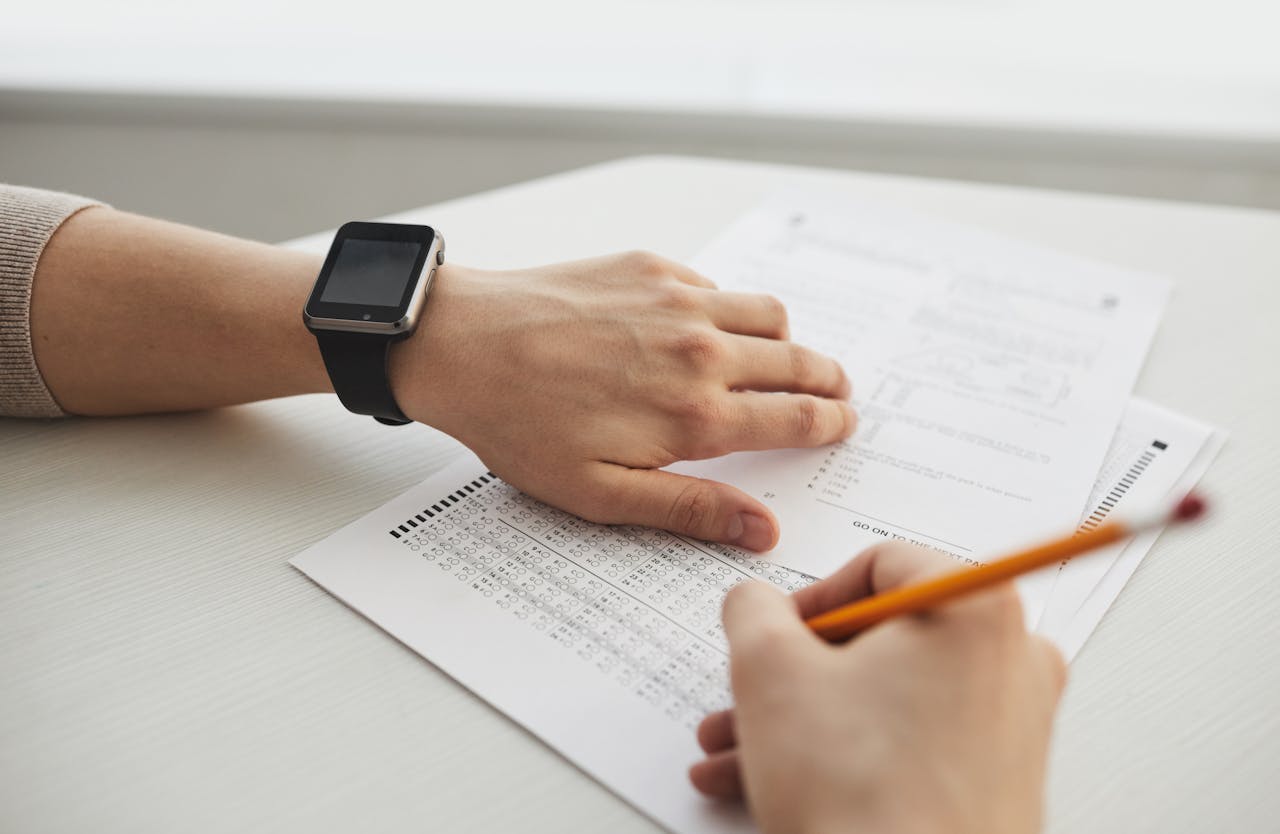 Student completing a multiple-choice exam with a pencil, close-up view.